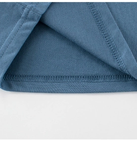 Detail view of double-needle stitching on navy blue knit cotton kids t-shirt hem