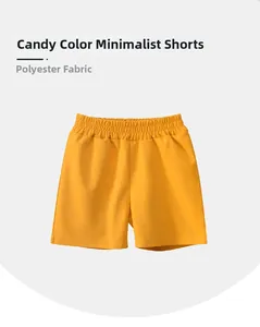 Detail of bright yellow kids quick-dry shorts featuring comfortable elastic waistband