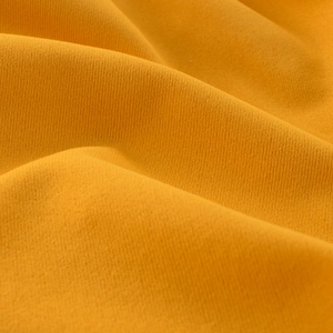 Macro shot of breathable yellow knit fabric texture on kids casual beach shorts