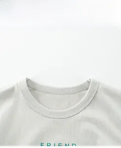 Macro shot of cotton round neck with green FRIEND print and double-stitched collar detail