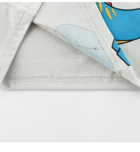 Close-up of double-needle stitching and hem detail on kids grey cotton dinosaur t-shirt