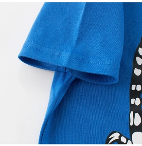 Detail of royal blue cotton T-shirt featuring double-stitch hem and dinosaur print