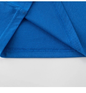 Close-up of high-quality double-stitched hem on a vibrant blue cotton kids' t-shirt