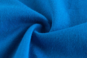 Macro shot of dark blue cotton knit fabric showing soft texture and weave detail