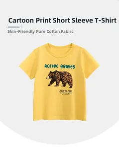 Detail of soft yellow cotton kids T-shirt featuring a cartoon brown bear and active text