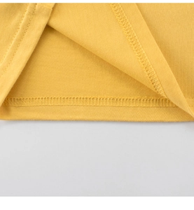Detailed close-up of double-needle hem stitching on yellow cotton kids t-shirt