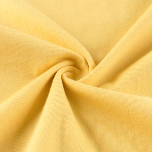 Detail of soft yellow cotton knit fabric texture with high quality fiber weaving