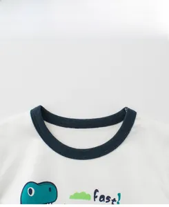 Detail of dark blue ribbed neckline on white cotton t-shirt with green dinosaur print