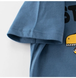 Detail of double-needle sleeve stitching and yellow dinosaur print on grey-blue cotton T-shirt