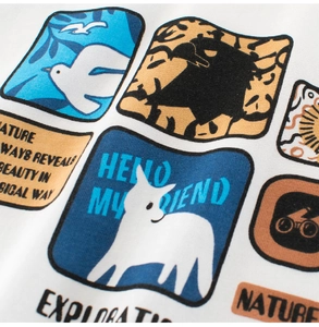 Detail of white cotton boy's t-shirt showing colorful cartoon prints and fabric texture
