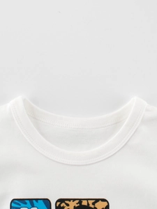 Close-up of boys' white cotton T-shirt ribbed neckline with animal print detail
