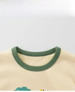 Gros plan du col rond côtelé vert foncé et des coutures sur un t-shirt en coton beige