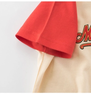 Detail of red raglan sleeves and premium cotton stitching on kids' printed graphic t-shirt