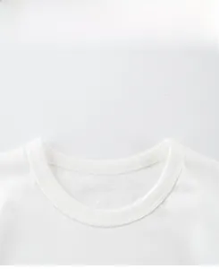 Close-up of white crew neck cotton t-shirt showing double-needle stitching details
