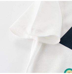 Detailed view of sleeve stitching and soft cotton fabric on kids white dinosaur t-shirt