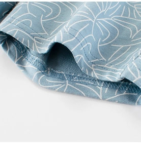 Close-up of light blue French Terry fabric with white floral prints and fine stitching