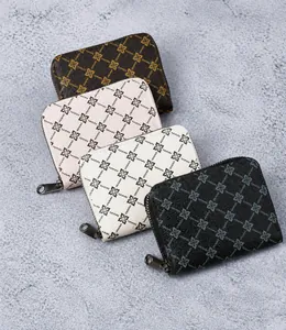 Stack of four colorful zippered card wallets with geometric floral print patterns