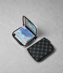 Macro detail of multi-slot accordion card holder with gray clover pattern and pink lining