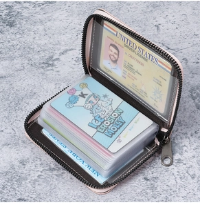 Detail view of pink zipper card holder with multiple transparent slots for ID and bank cards