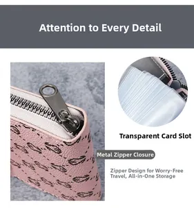 Detail view of the metal zipper and transparent internal card slots of the pink wallet