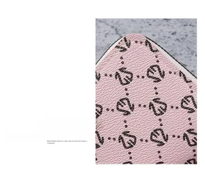 Macro view of pink litchi grain leather texture and precise stitching on the card holder