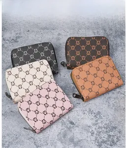Detailed view of multi-color faux leather card wallets with swan logo and U-shaped zippers