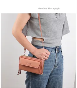 Detail view of pink crossbody bag with double zipper pockets and front flap on a model
