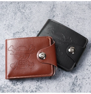 Detail of bifold wallet featuring lychee texture and One Piece skull embossed logo