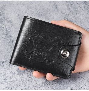 Close-up of textured black leather wallet featuring embossed One Piece skull logo design