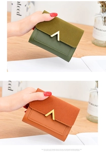 Close-up of green and brown frosted leather wallets with stylish gold V-metal buckles