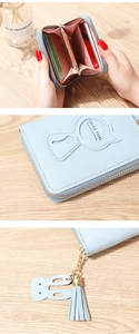 Detalle de la billetera azul claro con grabado de gato y ranuras para tarjetas