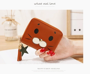 Close-up of brown cat-themed short wallet with cute ear details and star tassel