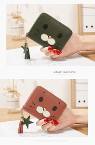 Close-up of cute animal face coin purses with tassel zipper charms in green and brown