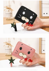 Close-up of cute cartoon seal wallet with heart metal stud and star tassel charm