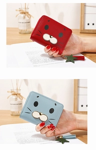 Detail of red and blue cartoon seal wallets featuring zipper closure and star tassel
