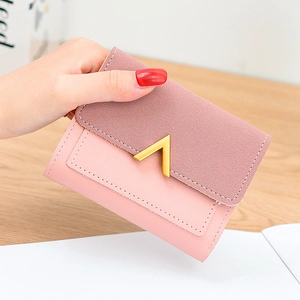 Pink and purple contrast bifold wallet with gold V-shape buckle on wooden background