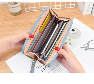 Internal view of long blue wallet showing spacious slots for cards and a smartphone