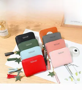 Detailed view of colorful short zip wallets featuring lychee texture and star tassel charms