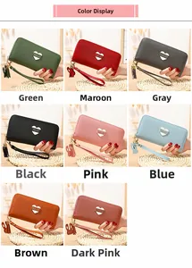 Detailed close-up of multiple colorful long wallets with heart hardware and wristlet straps