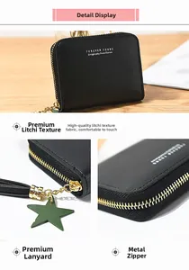 Close-up of black litchi pattern wallet featuring metal zipper and tassel star charm