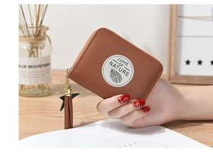 Brown PU leather mini wallet detail with tassel charm and Love of Nature logo