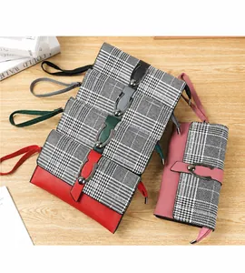 Detalle de carteras largas para mujer en cuatro colores con correas y cremalleras