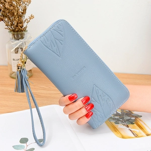 Light blue long wallet with maple leaf embossing, zipper closure, and tassel strap