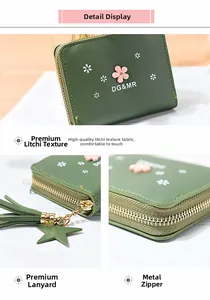 Detail of dark green litchi grain PU leather wallet with floral print and star tassel