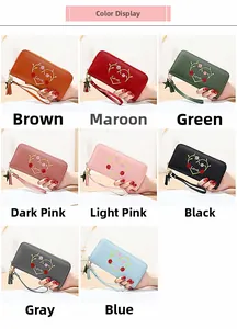 Color display of long zipper wallets with heart embroidery available in eight diverse shades