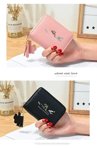 Detail of short PU leather zip wallets with dolphin metal charms and tassel pendants