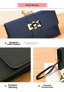 Detailed view of lychee pattern leather handbag with metal buckle and wrist strap