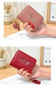 Detail of short women's wallets with dolphin charm, tassels, and cute fish house printing