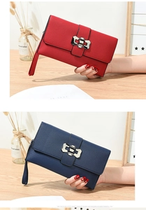 Detail of red and navy litchi texture handbags with silver bow clasp and hand straps