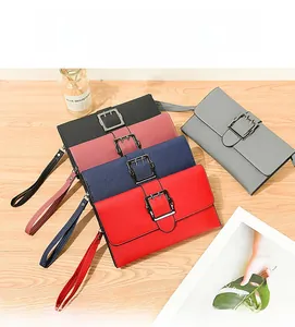 Macro shot of stylish long wallets in multiple colors with pebbled texture and metal buckles